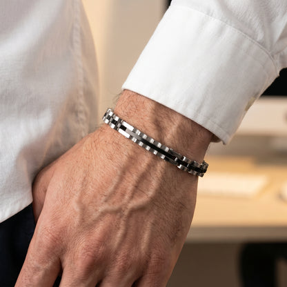 Elegant Silver & Black Stainless Steel B-133 Bracelet worn on a man's wrist, showcasing a stylish design and polished finish.