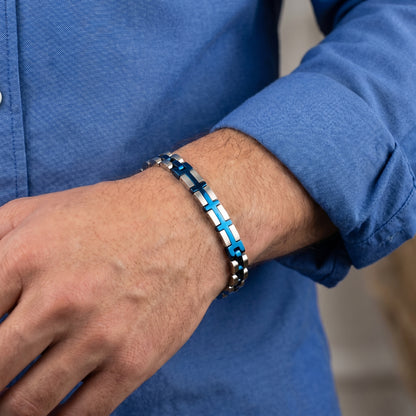 Elegant Silver & Blue Stainless Steel B-132 Bracelet on a man's wrist, featuring a modern design with interlocking links.
