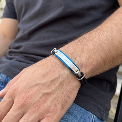 Blue and silver bar bracelet with black braided leather straps on forearm