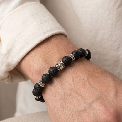 Obsidian Conduit Bundle B-123 G-12 men's bracelet featuring black lava beads and silver accents, worn on a wrist.