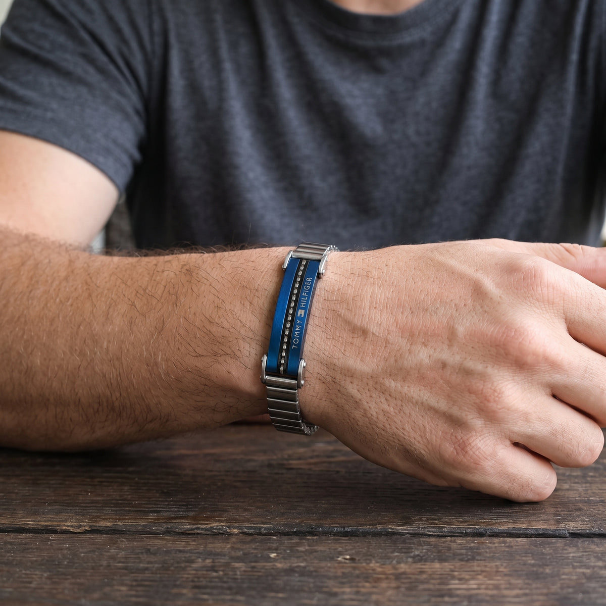 Men's stainless steel ID link bracelet with blue strip worn on wrist