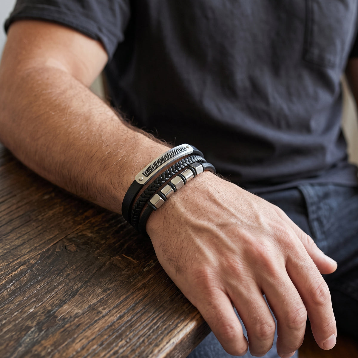 Men's black leather bracelet with silver Greek key metal centerpiece, adjustable