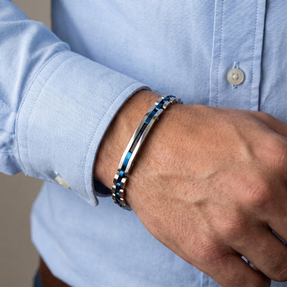 Blue-accent stainless steel bracelet on wrist with light blue shirt cuff