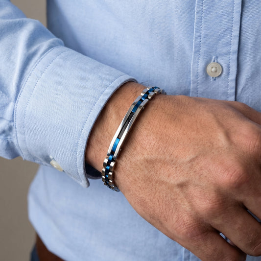 Blue-accent stainless steel bracelet on wrist with light blue shirt cuff