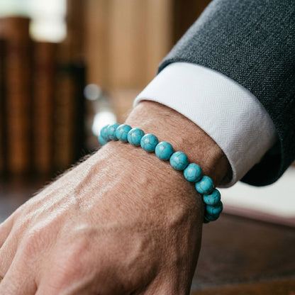 Azure Serenity Bundle G-7 B-87 men's bracelet featuring turquoise beads worn on a wrist, set against a stylish background.