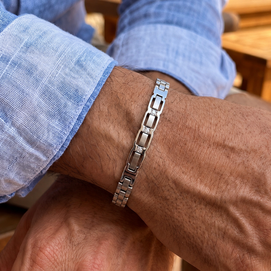 Silver stainless steel zircon link bracelet with rectangular segments, worn on wrist