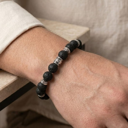 Obsidian Conduit Bundle B-123 G-12 men's bracelet featuring black lava stones and silver accents, worn on a wrist.