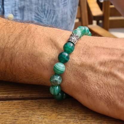 Green agate bead bracelet on arm with ornate silver-tone centerpiece