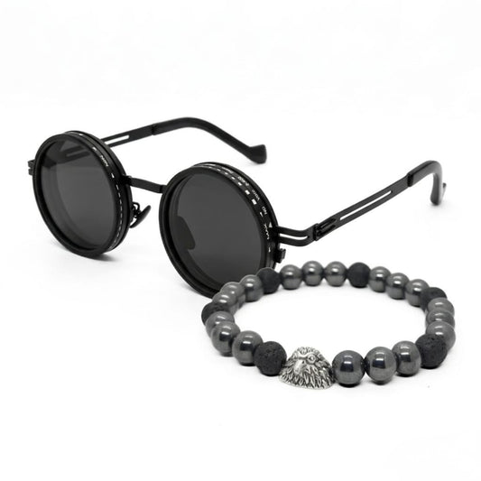 Men's sunglasses with round black frames and dark lenses, paired with a beaded bracelet featuring silver and black stones.