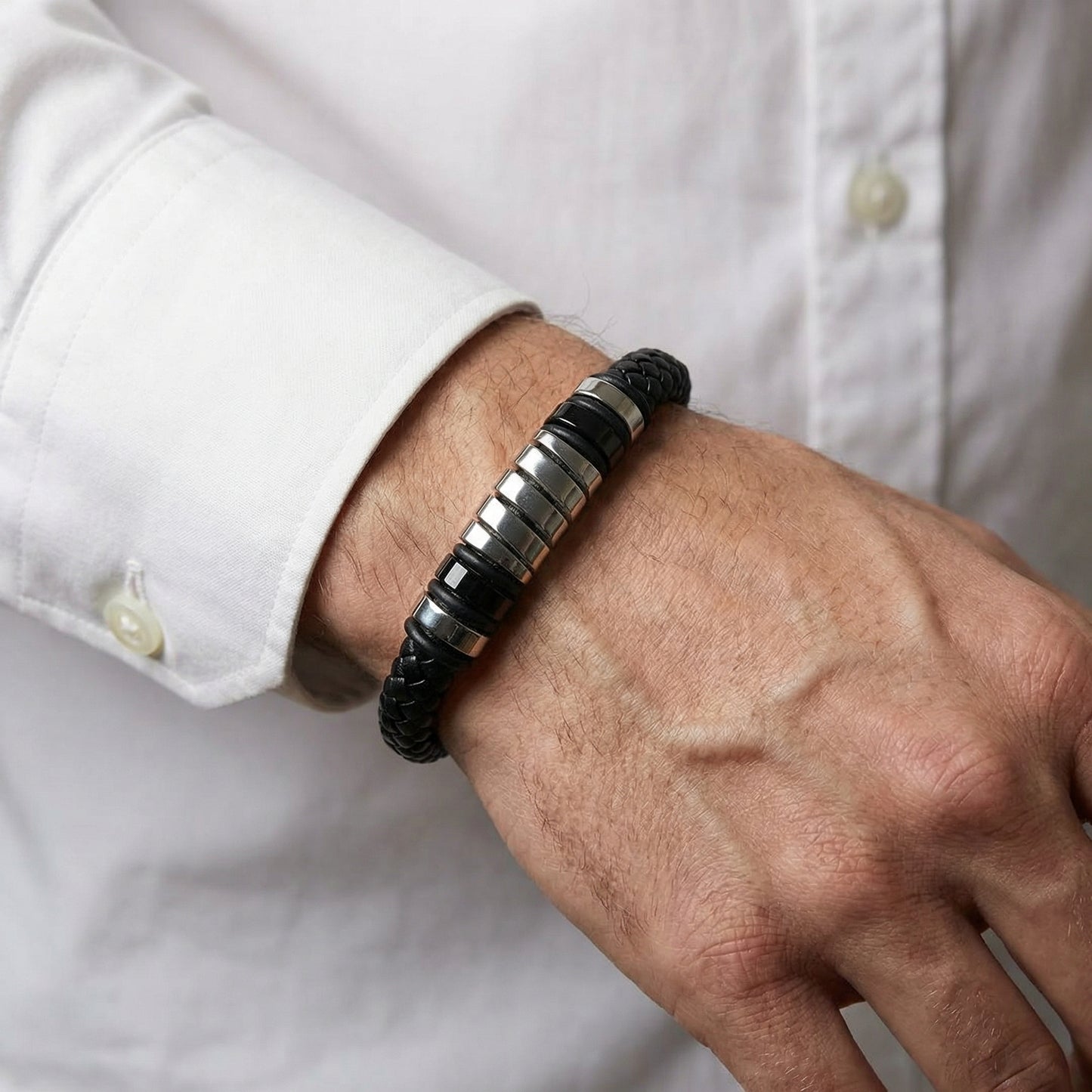 Men's Cobalt Nexus Bundle B-124 B-87 bracelets featuring black leather and metallic accents, worn on a wrist.