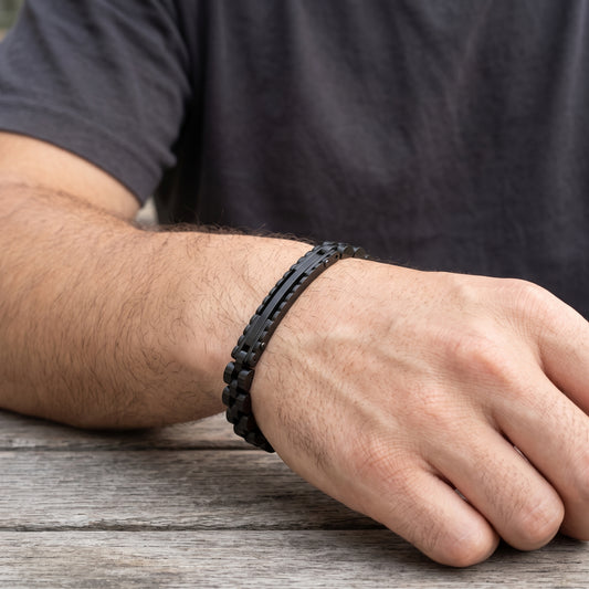 Black stainless steel ID link bracelet with rectangular links on forearm