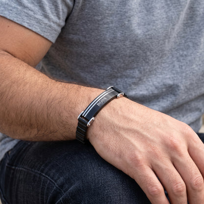 Men's black stainless steel ID bracelet with silver lines and clasp on wrist
