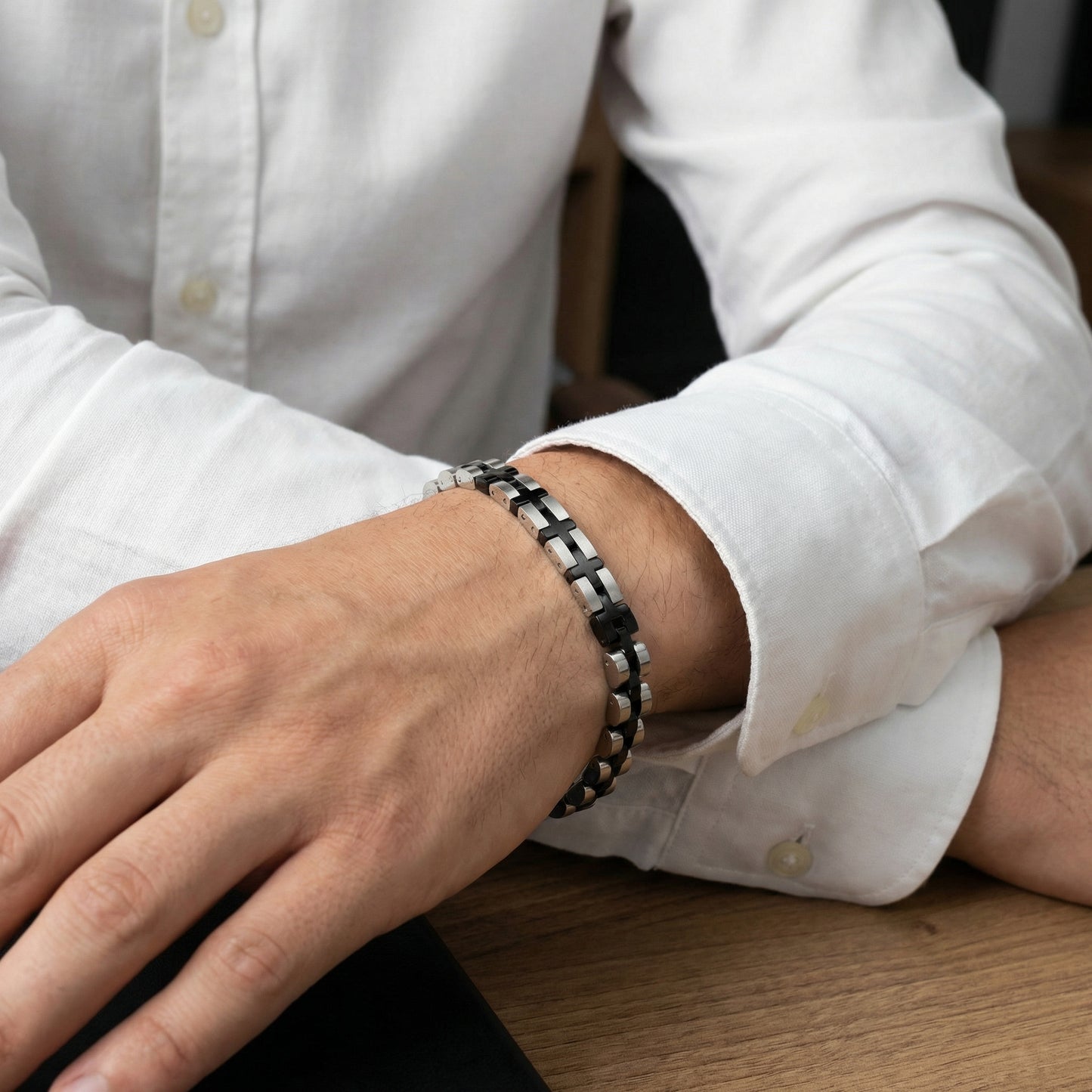 Stainless steel duo bracelet with alternating silver and black links, worn on wrist