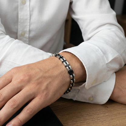 Stainless steel duo bracelet with alternating silver and black links, worn on wrist