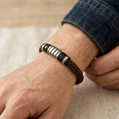 Luxury brown leather and silver stainless steel B-126 bracelet worn on a wrist, showcasing a stylish braided design.