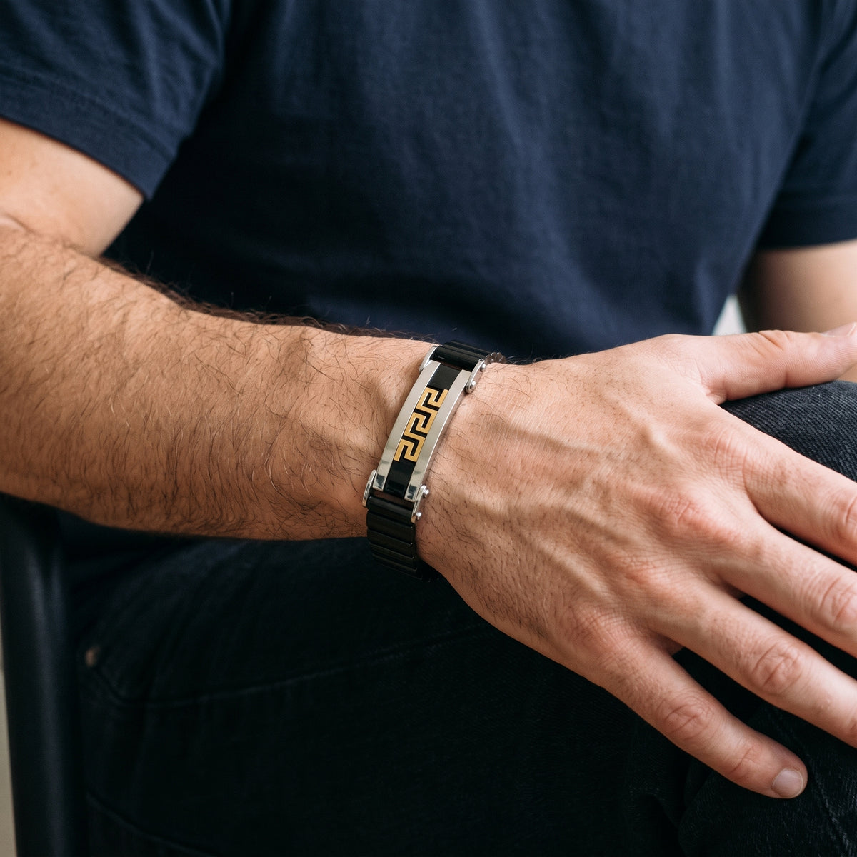 Men's Greek key cuff bracelet featuring gold pattern in silver with black link segments