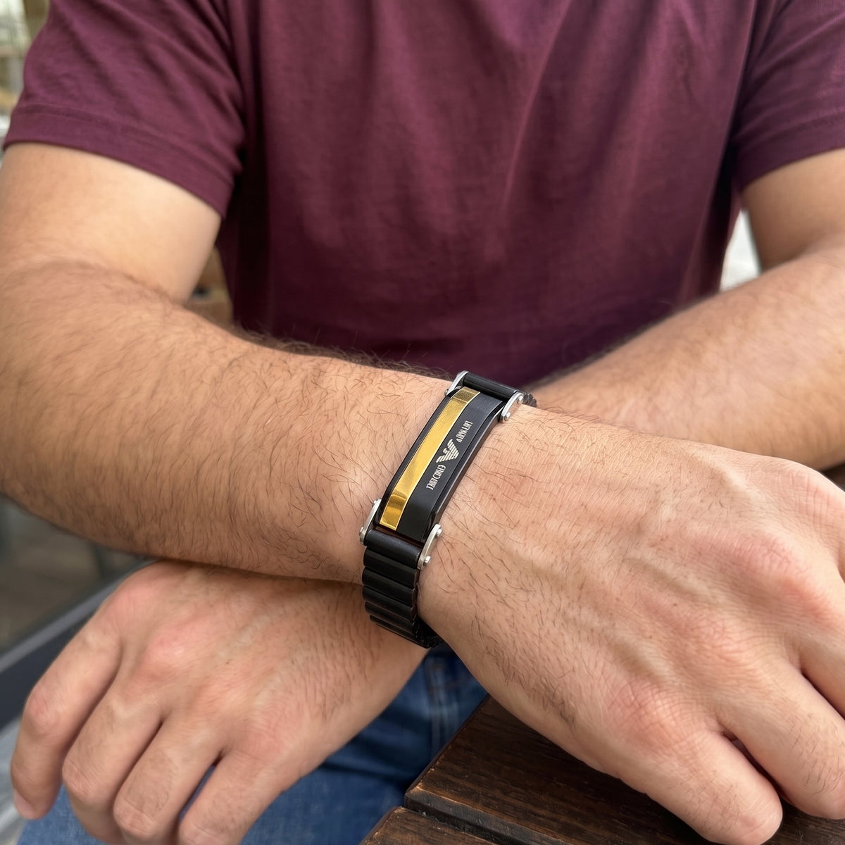 Men's black stainless ID bracelet with gold stripe, watch-style clasp on wrist