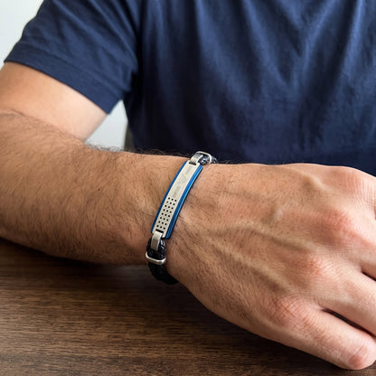 Adjustable bracelet with blue perforated panel and silver clasp, worn on forearm